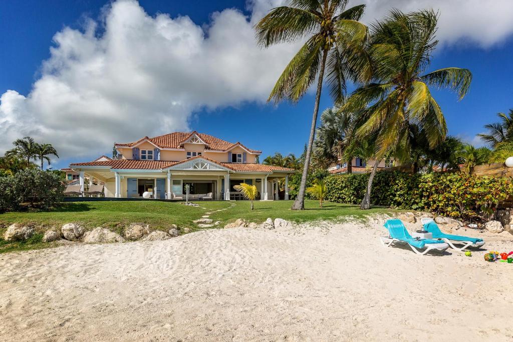 una casa con due sedie in spiaggia di Villa Marine 5 étoiles sur la plage du lagon à deux pas du golf a Saint-François