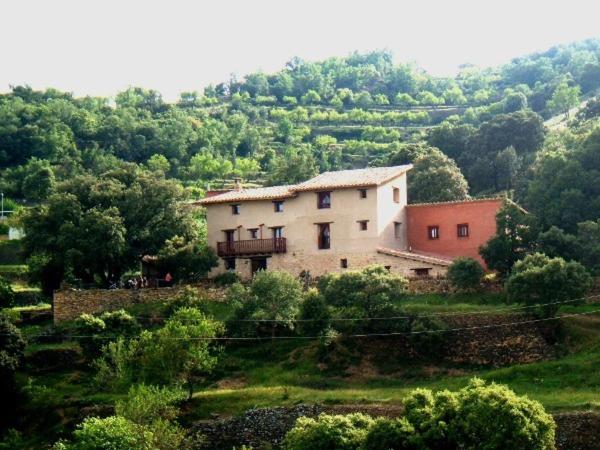 a large house on a hill in a field at Masico Santana in Todolella