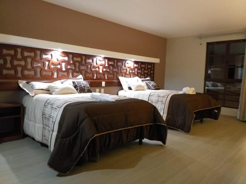 Postel nebo postele na pokoji v ubytování 9 Estrellas Casa Hotel