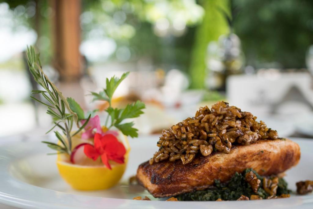 a plate of food with a piece of meat with nuts at Holiday Resort in Velika Slatina