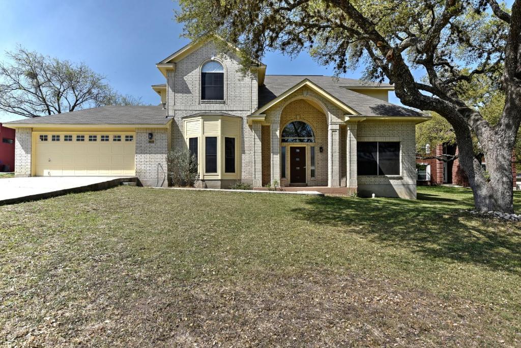 a house with a large yard in front of it at The Richard John House in San Antonio