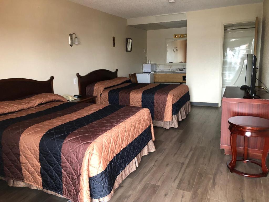 Postel nebo postele na pokoji v ubytování Red Deer Inn & Suites