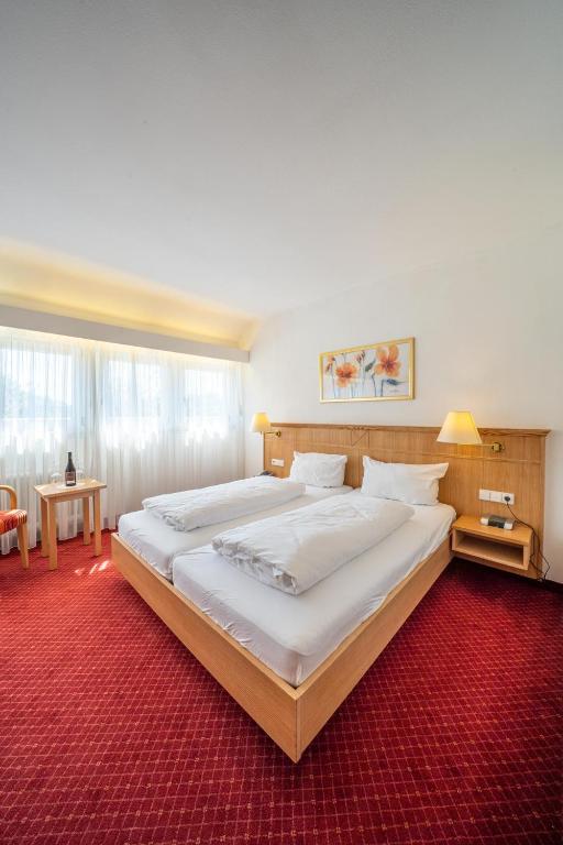 Postel nebo postele na pokoji v ubytování Weinhotel Pfeffer & Salz