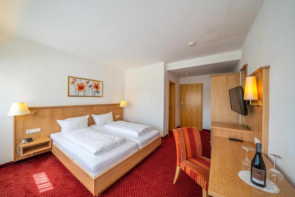 Postel nebo postele na pokoji v ubytování Weinhotel Pfeffer & Salz