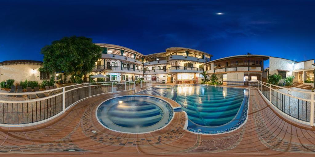 a swimming pool in front of a building at El Virrey Hotel Boutique in Honda