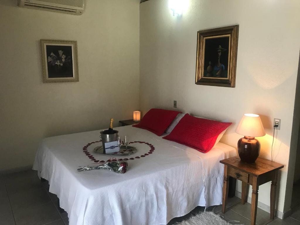 a bedroom with a bed with a candle on it at Pousada Irmãos do Mar in Ilhabela