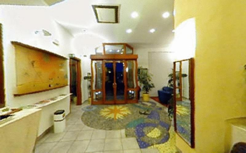 a living room with a large room with a floor at Albergo Fiorenza in Salerno