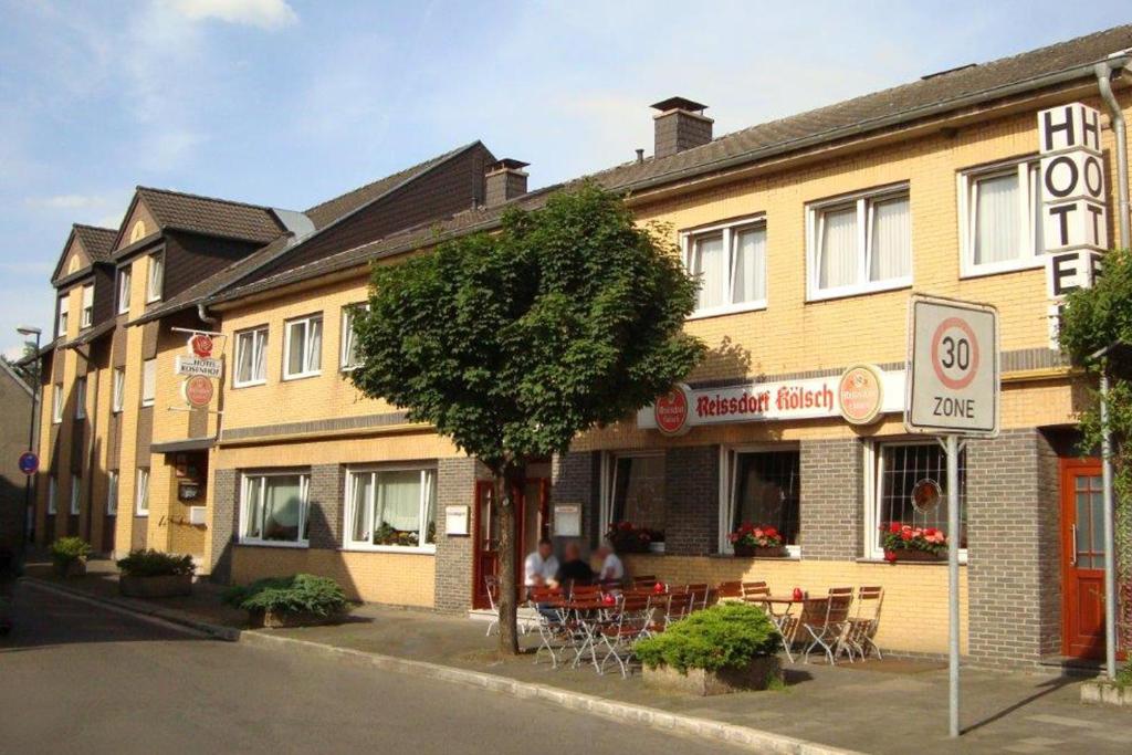 a building with a restaurant on the side of a street at Hotel Rosenhof in Kerpen