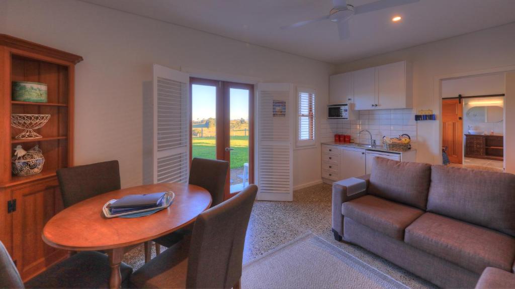 a living room with a table and a couch at Bridle Guesthouse in Maleny