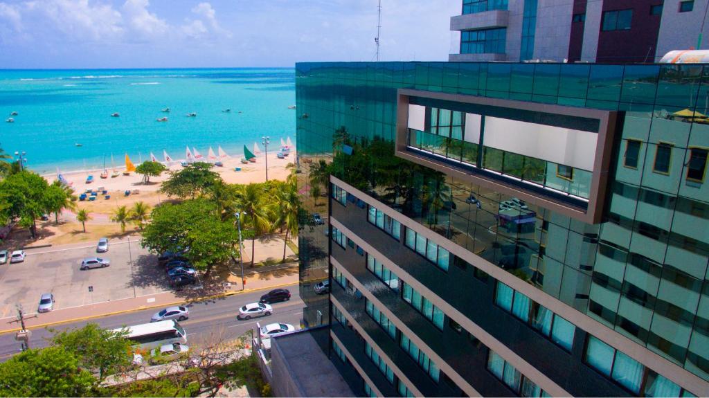 a view of the ocean from a building at Acqua Suítes Maceió in Maceió