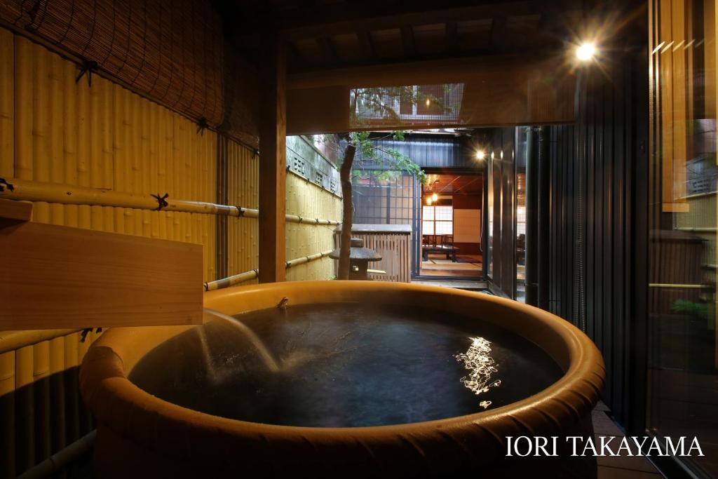 a bath tub in the middle of a room at IORI Stay in Takayama