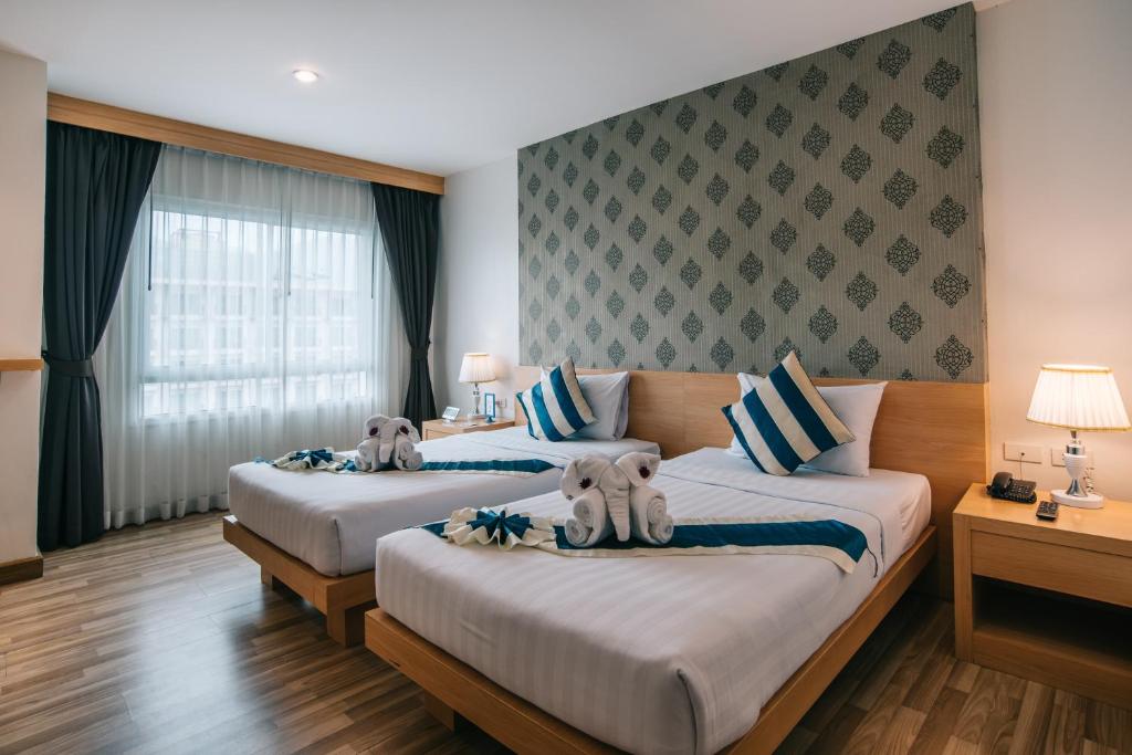 Postel nebo postele na pokoji v ubytování iCheck inn Central Patong