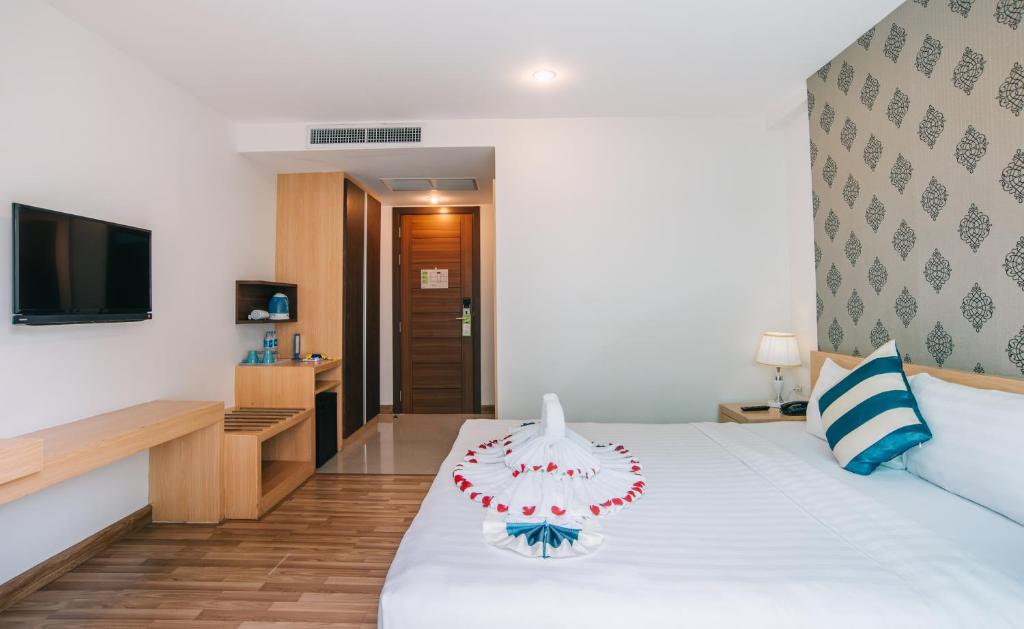 Postel nebo postele na pokoji v ubytování iCheck inn Central Patong