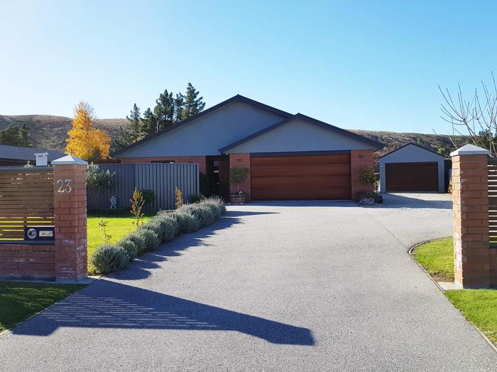 a driveway leading to a house with a garage at 23onAlbert in Clyde