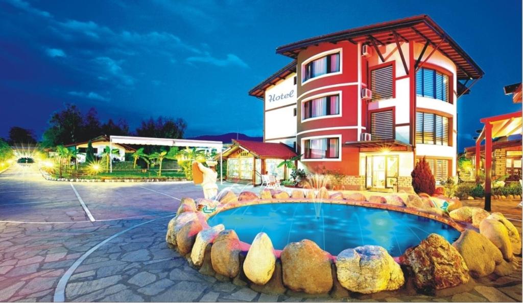 莫姆奇爾格勒的住宿－馬卡匝大廈旅館，一座带游泳池的度假村,位于一座建筑前