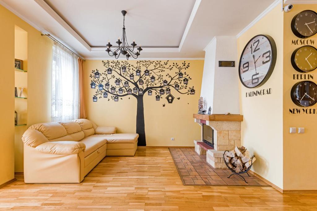 a living room with a tree mural on the wall at Skvorechnik in Kaliningrad