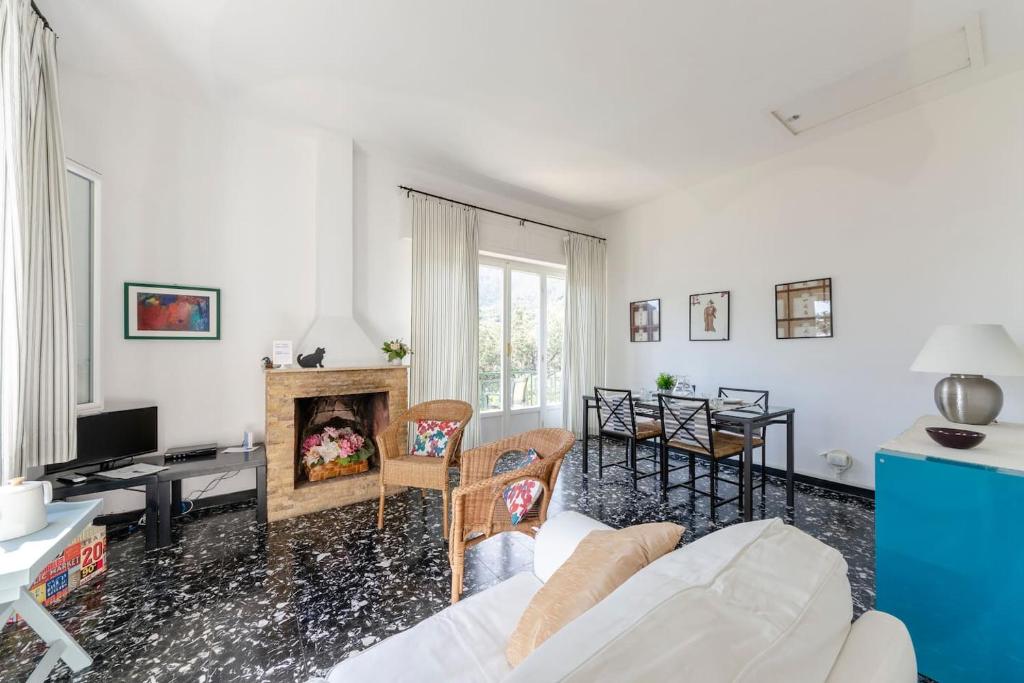 a living room with a couch and a fireplace at JOIVY Sea View Flat with Balcony, Cinque Terre in Monterosso al Mare