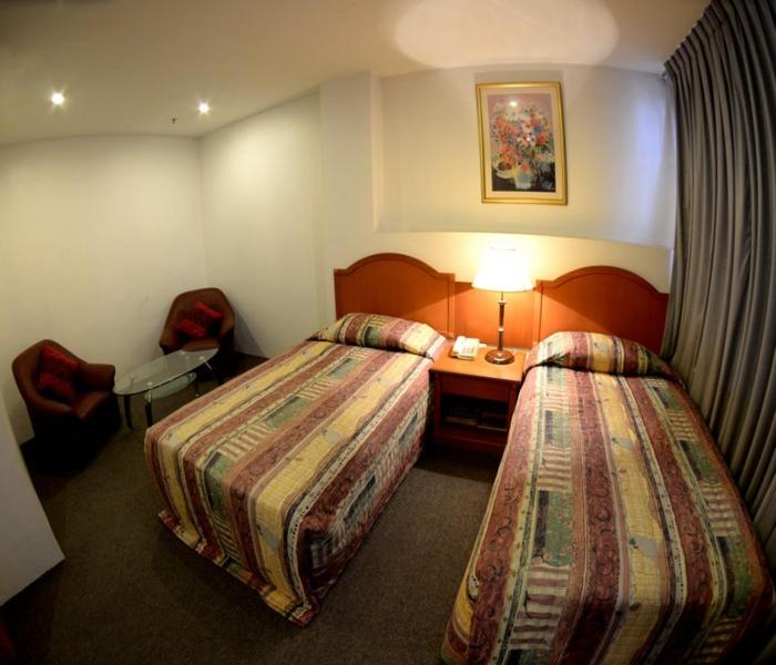 Postel nebo postele na pokoji v ubytování Kawan Hotel