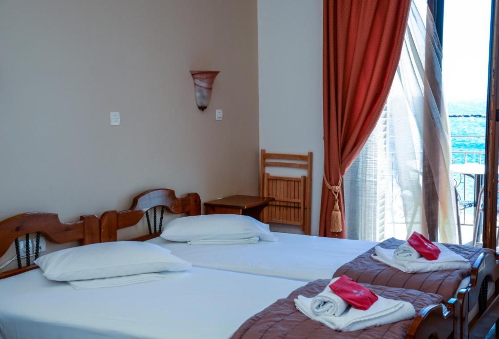 Postel nebo postele na pokoji v ubytování Poseidonio Hotel