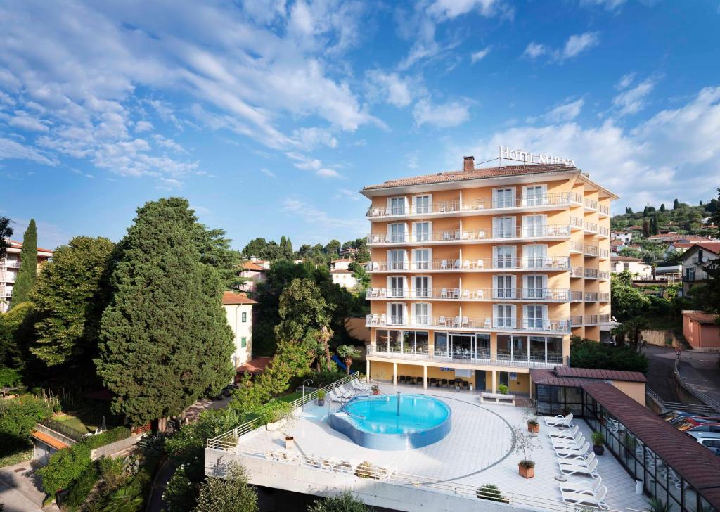 ein Hotel mit einem Pool vor einem Gebäude in der Unterkunft Hotel Mirna - Terme & Wellness Lifeclass in Portorož