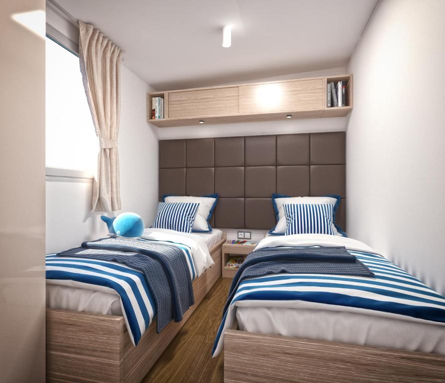 Posteľ alebo postele v izbe v ubytovaní Victoria Mobilehome in Istra Premium Camping Resort