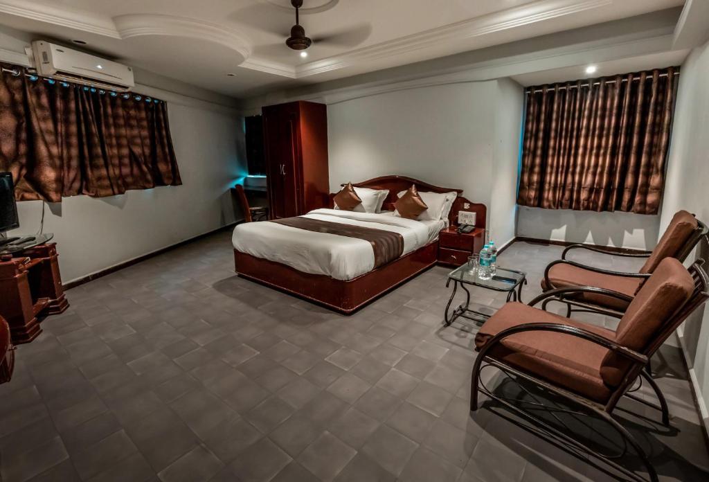 Postel nebo postele na pokoji v ubytování Hotel JMC Group