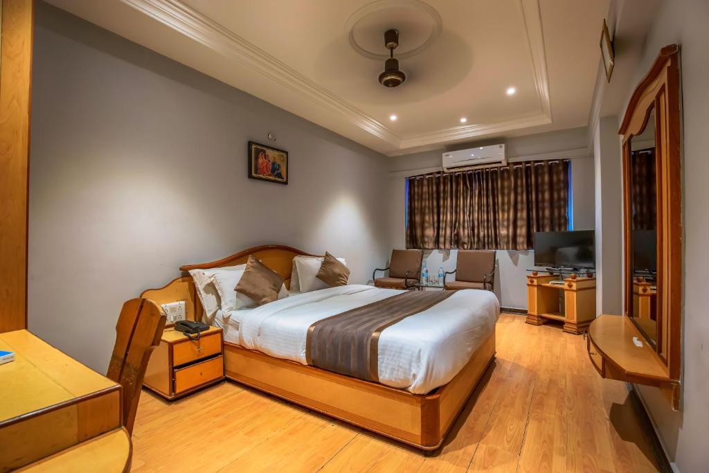 Postel nebo postele na pokoji v ubytování Hotel JMC Group