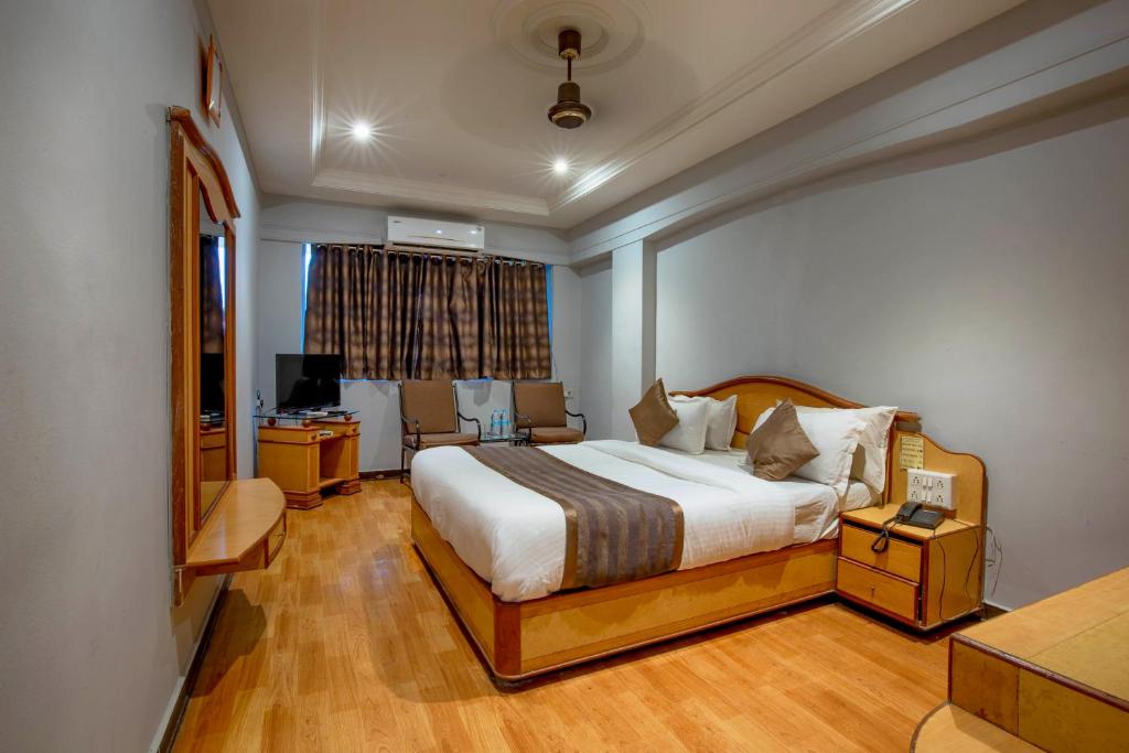 Postel nebo postele na pokoji v ubytování Hotel JMC Group