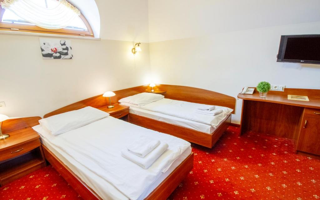 Posteľ alebo postele v izbe v ubytovaní Hotel Stary Młyn