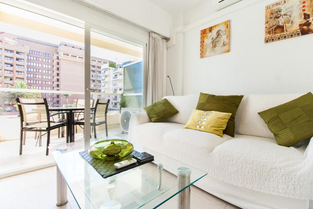 a living room with a white couch and a glass table at PYR Private Apartment SUNNY pool SIDE in Fuengirola