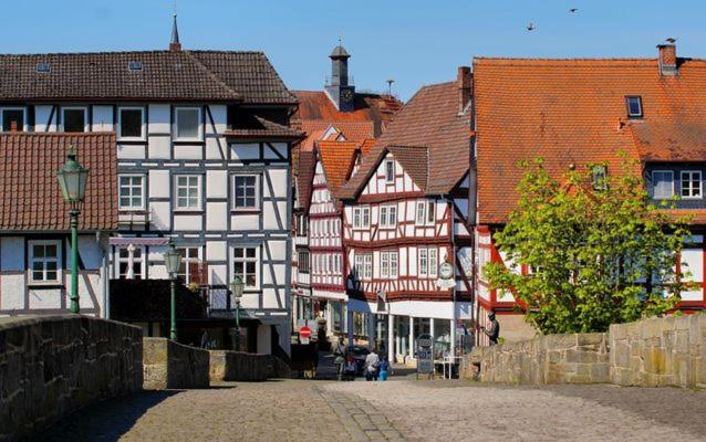 a group of buildings in a town with a street at Ferienwohnung Bartenwetzerbrücke in Melsungen