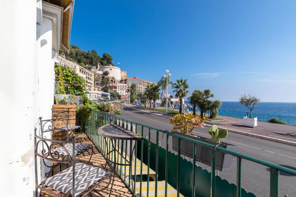 a balcony with a view of a street and the ocean at 6 bedrooms seaview house, Old Town in Nice