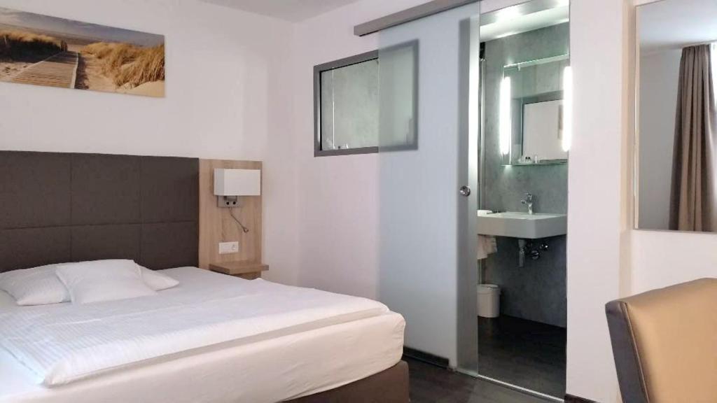 Postel nebo postele na pokoji v ubytování Hotel Hamann
