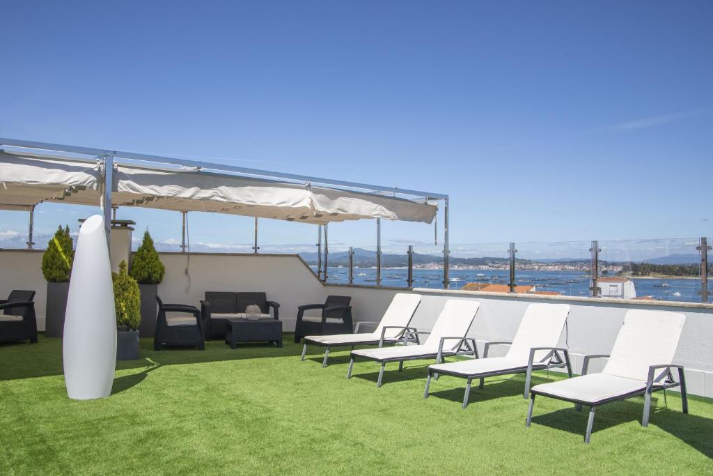 a group of chairs sitting on top of a roof at Hotel Maruxia *** Superior in O Grove