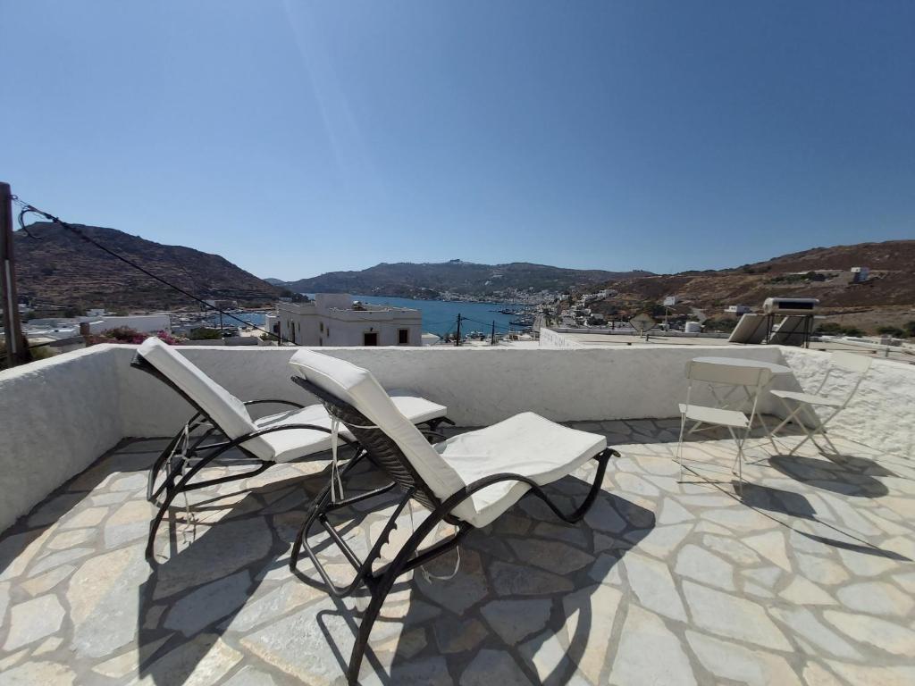 a group of chairs sitting on top of a roof at Studio 1 in Patmos