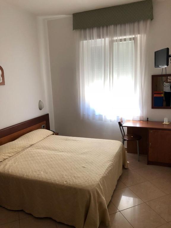 Postel nebo postele na pokoji v ubytování Hotel Rex