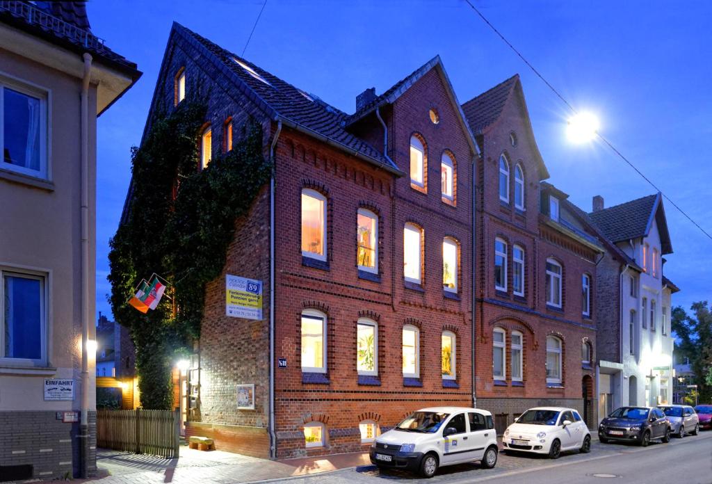 a large brick building with cars parked in front of it at Moltkestrasse 89 in Hildesheim