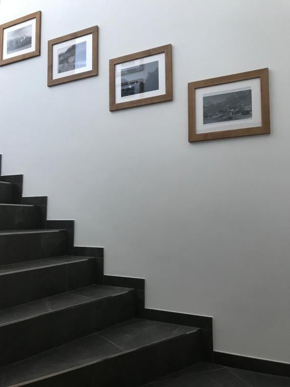 a staircase with two pictures on the wall and a stair case at Apartment Peotta in Volders