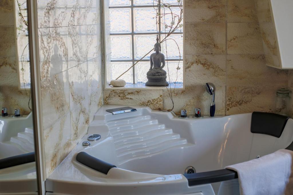 a bath tub in a bathroom with a window at AU BEAU RIVAGE AP2049 by RIVIERA HOLIDAY HOMES in Nice