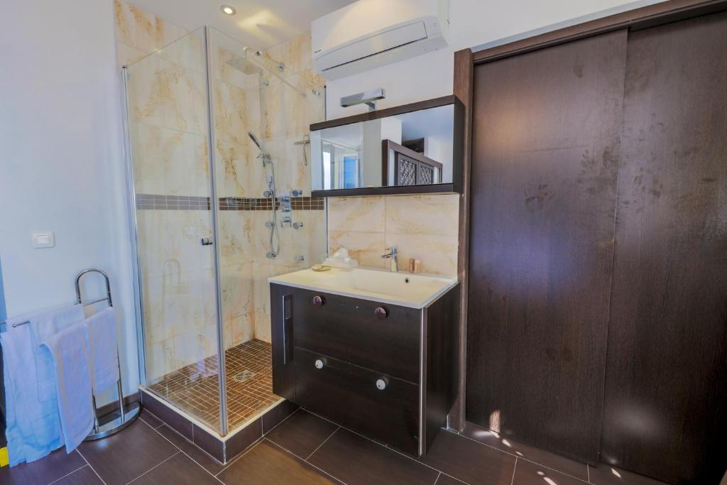 a bathroom with a sink and a shower at AU BEAU RIVAGE AP2049 by RIVIERA HOLIDAY HOMES in Nice