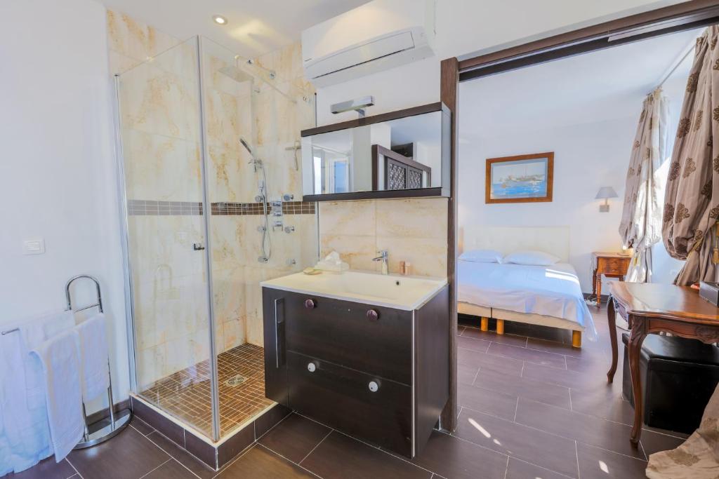 a bathroom with a shower and a sink and a bed at AU BEAU RIVAGE AP2049 by RIVIERA HOLIDAY HOMES in Nice