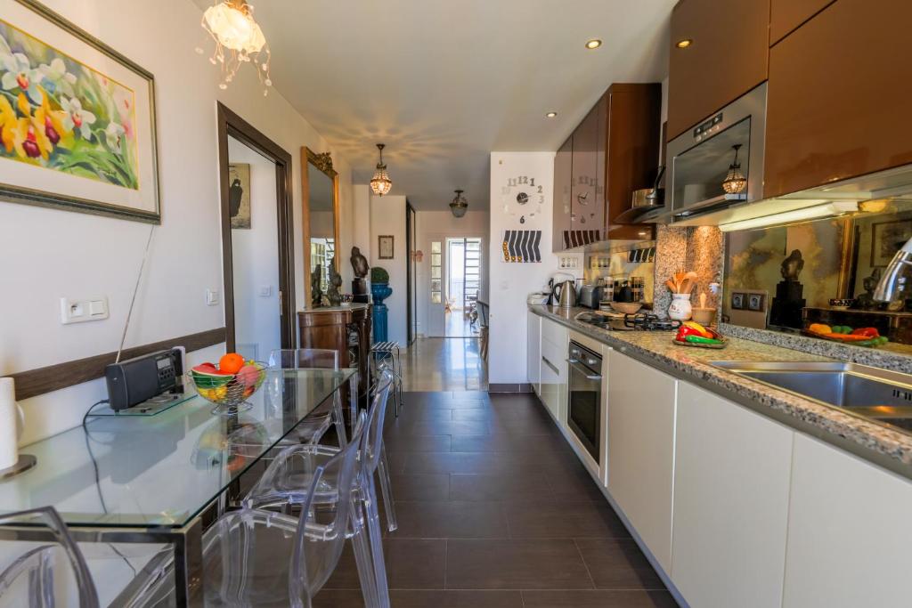 a kitchen with a counter with stools in it at AU BEAU RIVAGE AP2049 by RIVIERA HOLIDAY HOMES in Nice