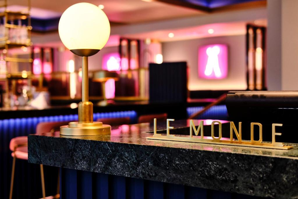 a bar with a table with the words lime wound at Le Monde Hotel in Edinburgh