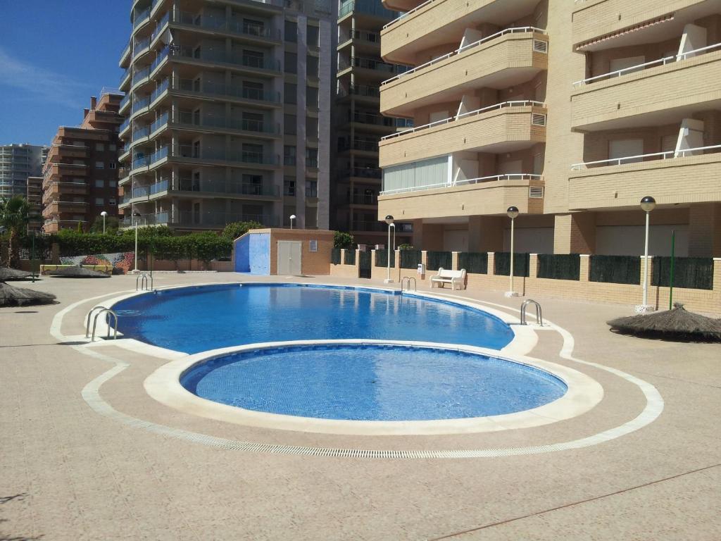 
a large swimming pool in front of a building at ACV- Cala Blanca II-1ª Linea Planta 4 Norte 2 in Oropesa del Mar
