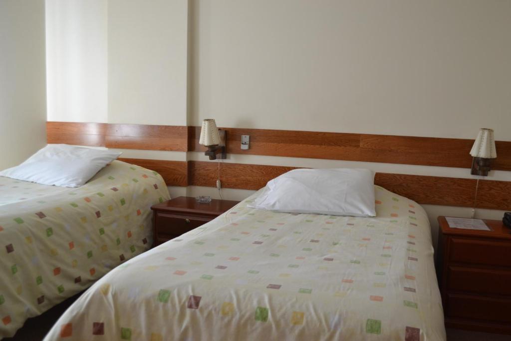 Postel nebo postele na pokoji v ubytování Suite Service Apart Hotel