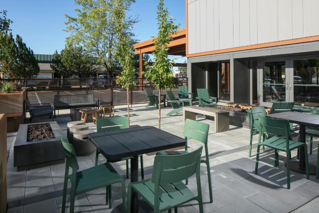 a patio with tables and chairs and a fire pit at Waypoint Hotel in Bend