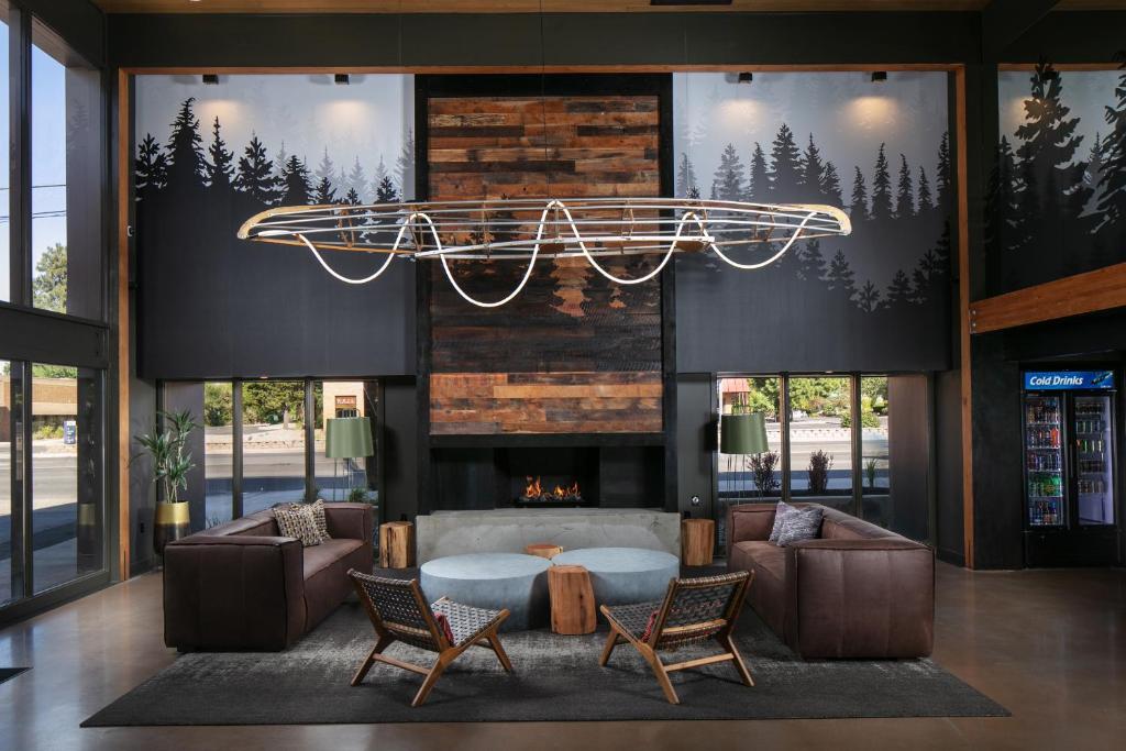 a lobby with a fireplace and a chandelier at Waypoint Hotel in Bend