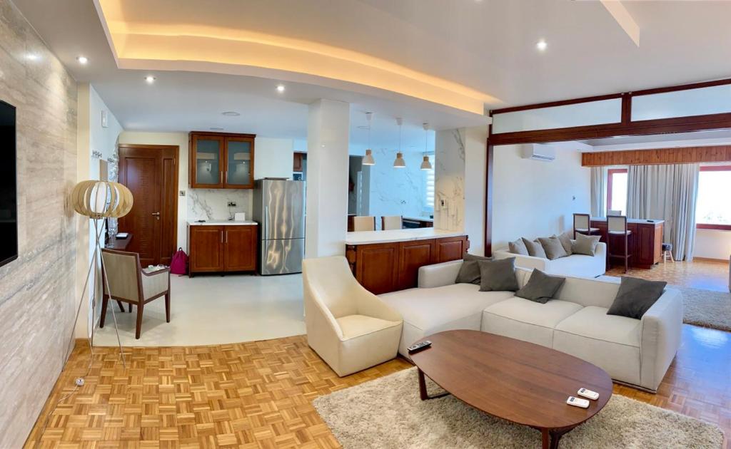a living room with a couch and a table at Modern 2 bed room large apartment in Nicosia