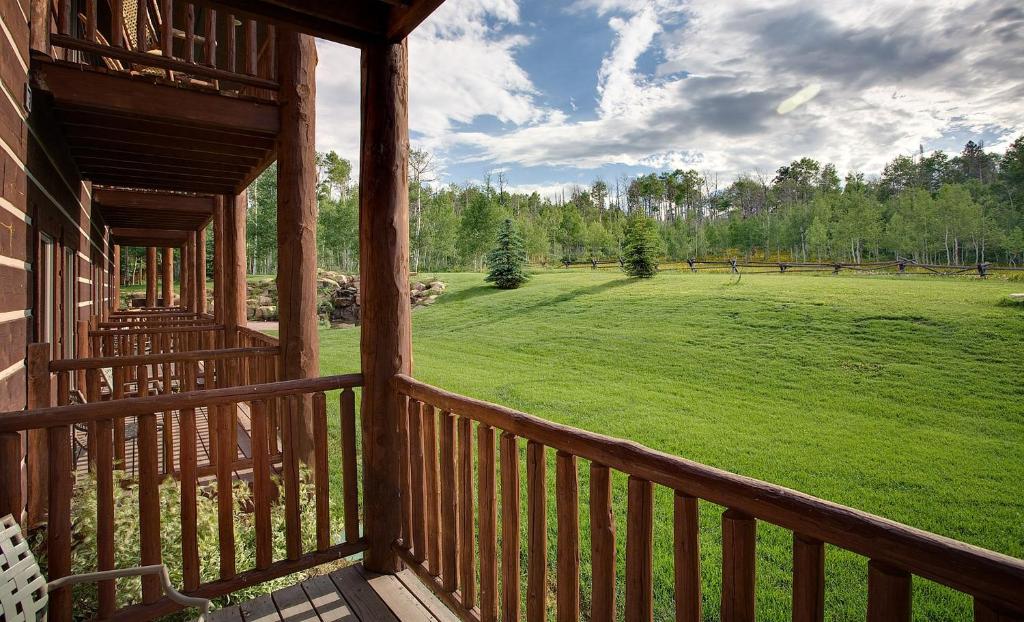 a view of a large green field from a porch at Daniels Summit Lodge in Wallsburg