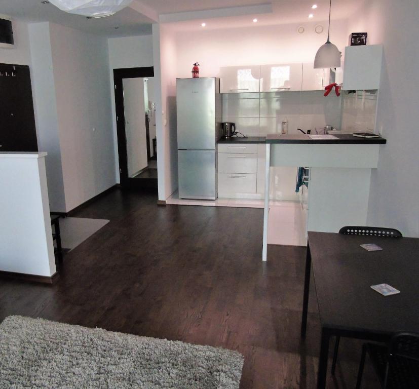 a kitchen with a counter and a refrigerator in a room at MOne - fajny apartament w centrum Wrocławia in Wrocław